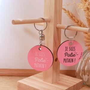Porte-clé humour texte blanc « Je suis polie putain » en bois rond